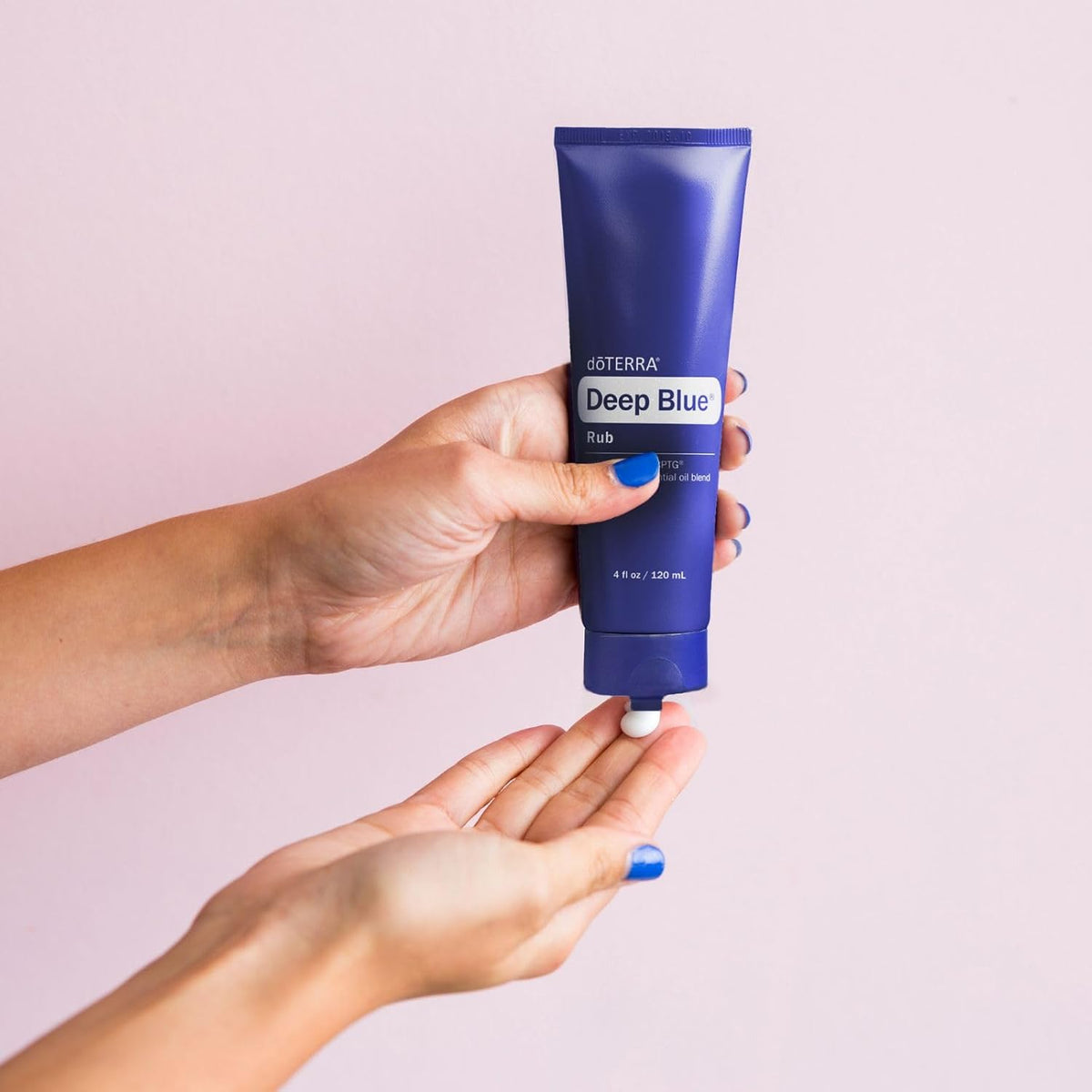doTERRA Deep Blue Rub 120 mL tube dispensing cream into a hand
