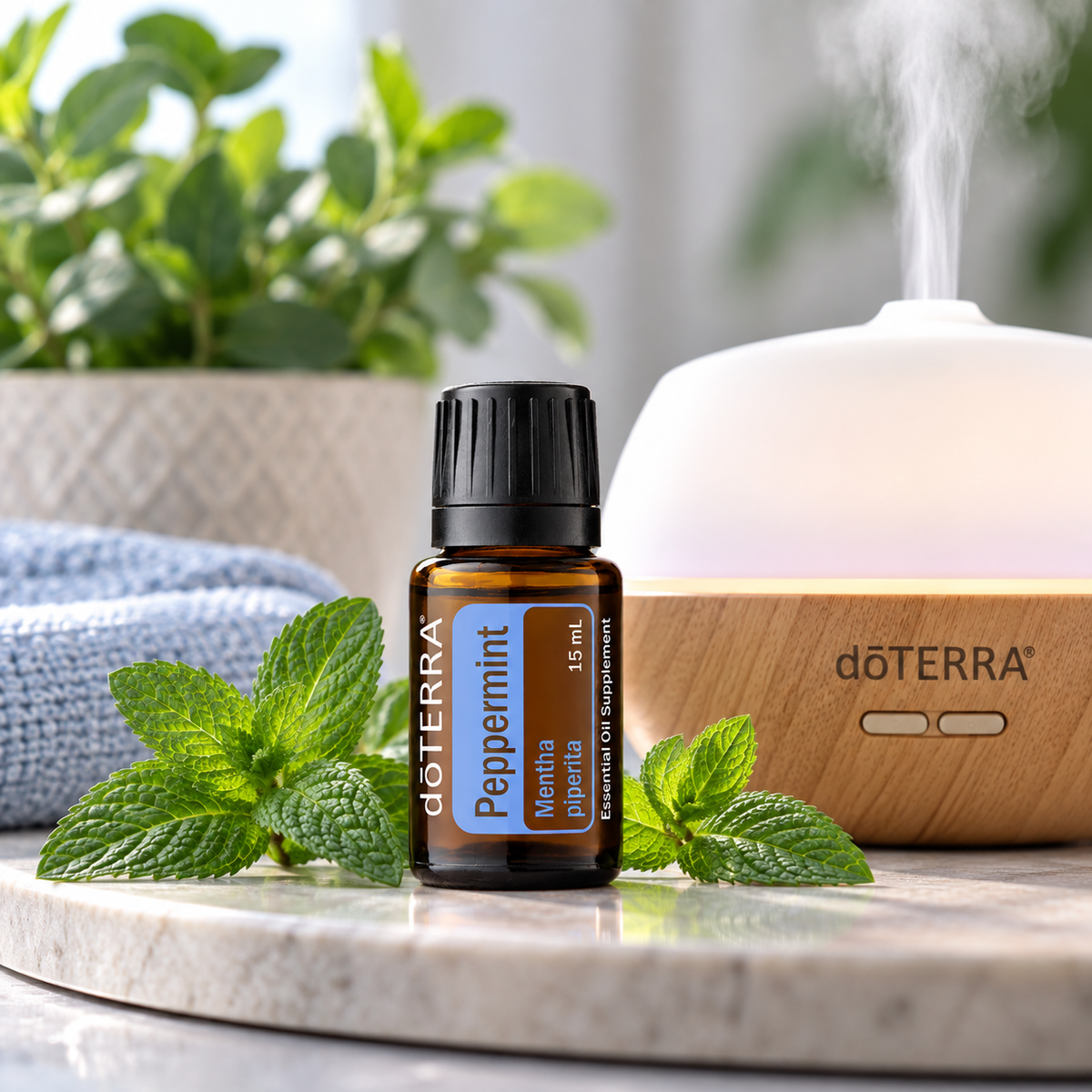 doTERRA Peppermint Essential Oil 15ml beside an essential oil diffuser
