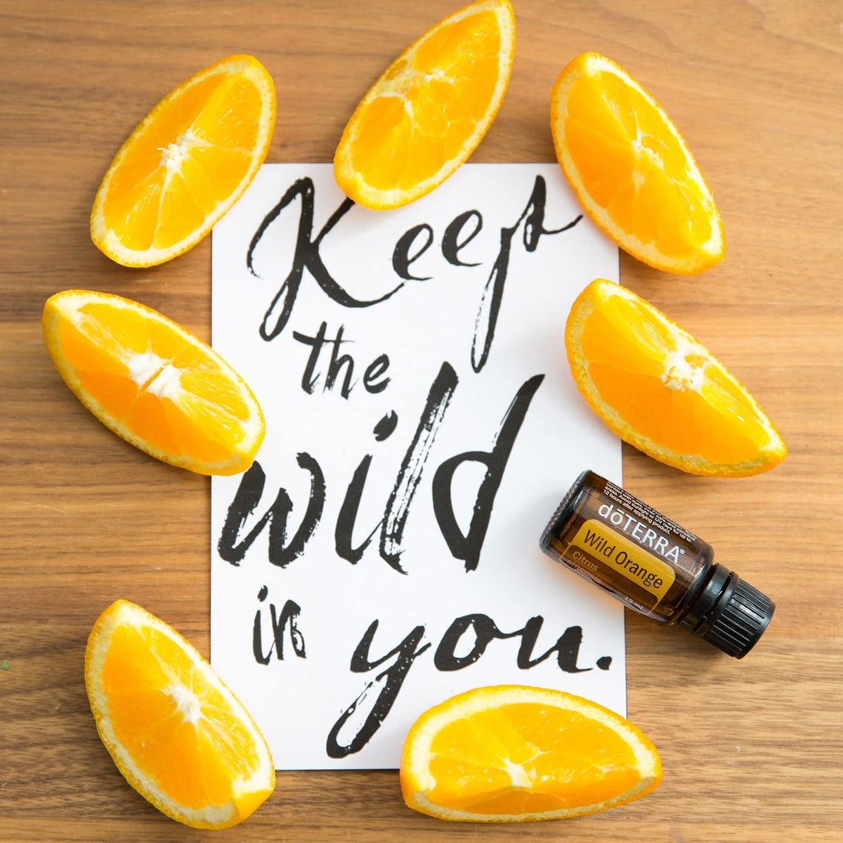 doTERRA Wild Orange Essential Oil 15 mL with fresh oranges