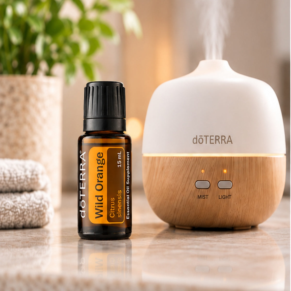 doTERRA Wild Orange Essential Oil beside an essential oil diffuser